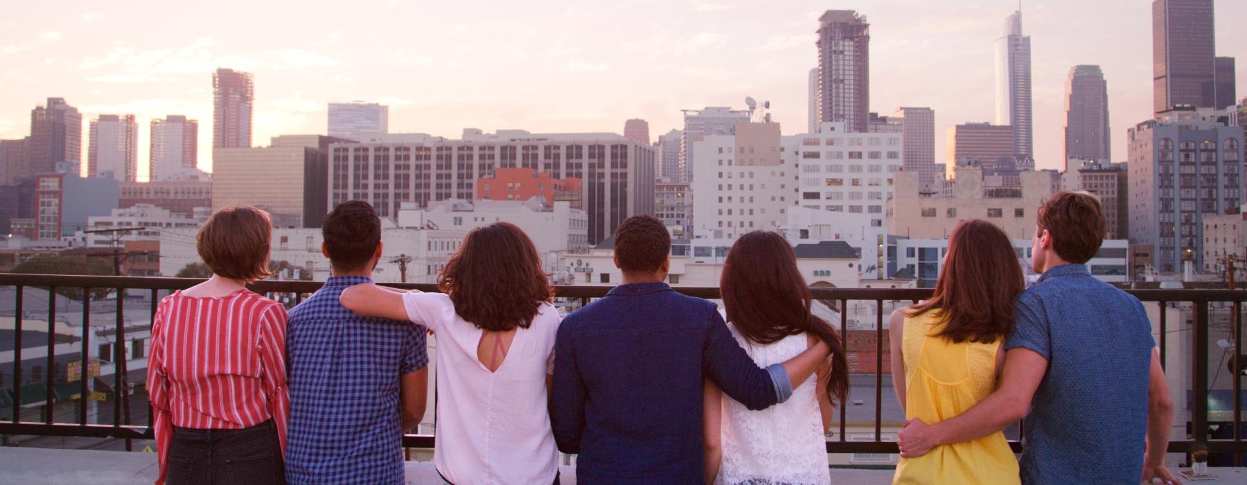 a group of people looking at a city
