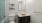 a bathroom with a sink, toilet, and mirror