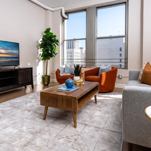 a living room with a tv and couches