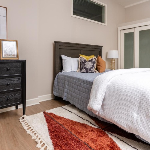 a bedroom with a bed and dresser