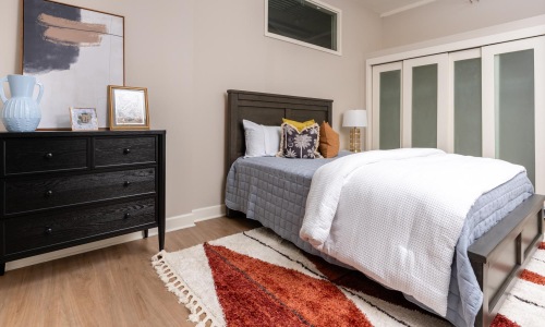 a bedroom with a bed and dresser