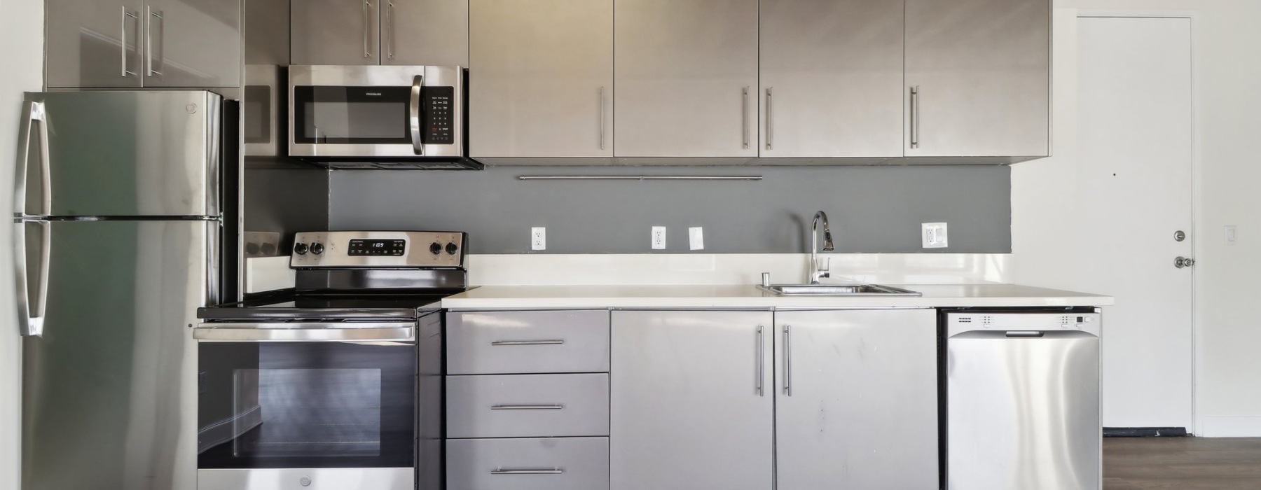 a kitchen with gray cabinets