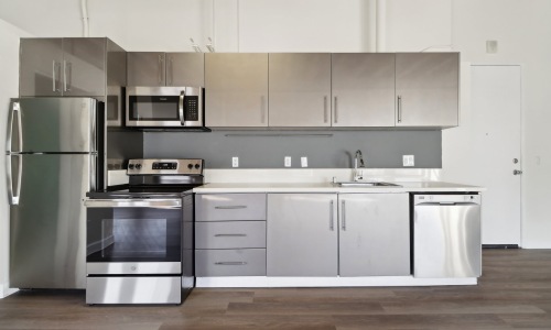 a kitchen with gray cabinets